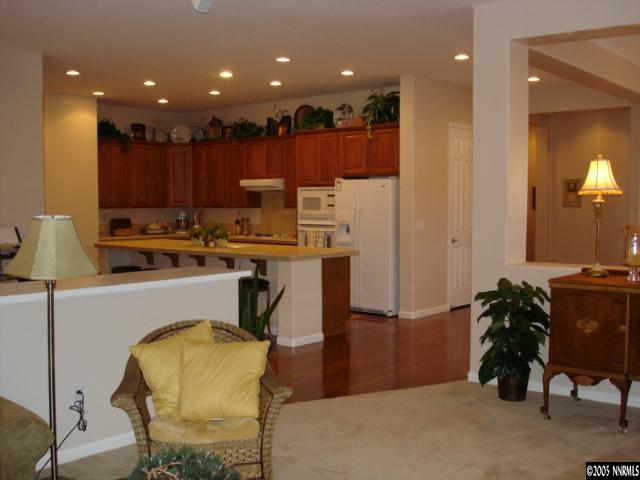 1698 Greycrest Way Reno, NV 89521 - Photo 3 of 6 a kitchen with kitchen island a table and chairs in it