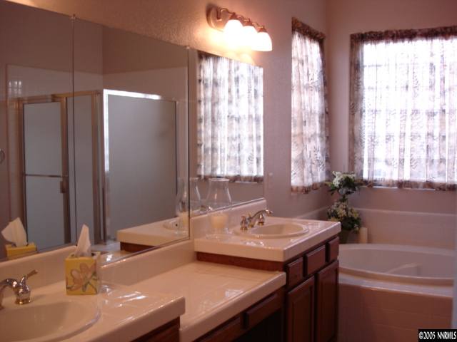 1698 Greycrest Way Reno, NV 89521 - Photo 6 of 6 a bathroom with double vanity and a bathtub