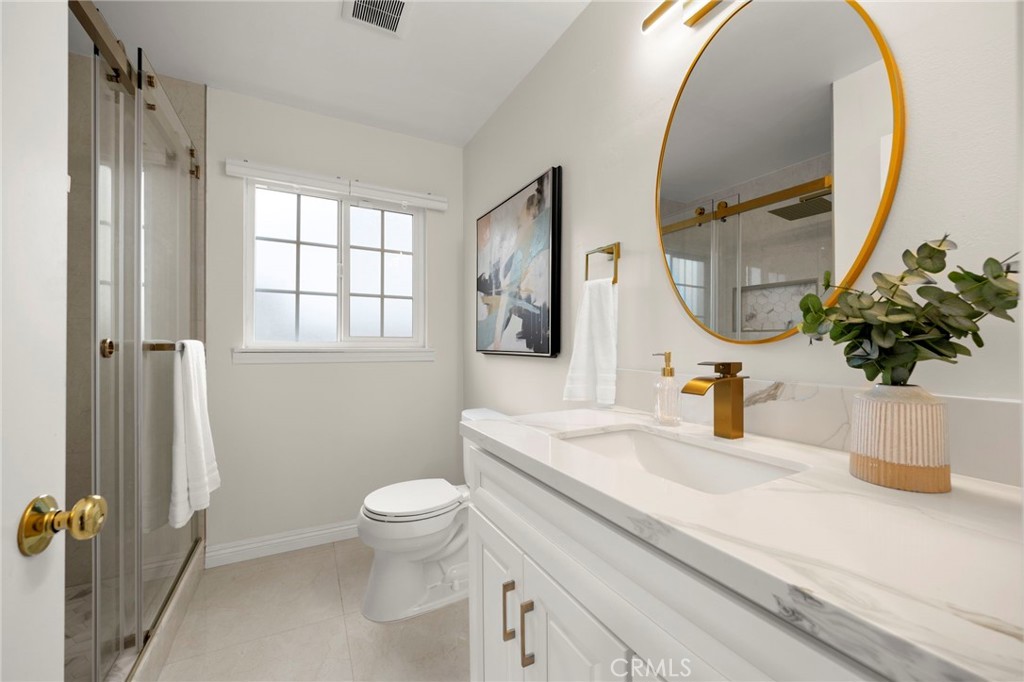 12817 Meadow Green Road La Mirada, CA 90638 - Photo 24 of 43 a bathroom with a sink a toilet and a mirror