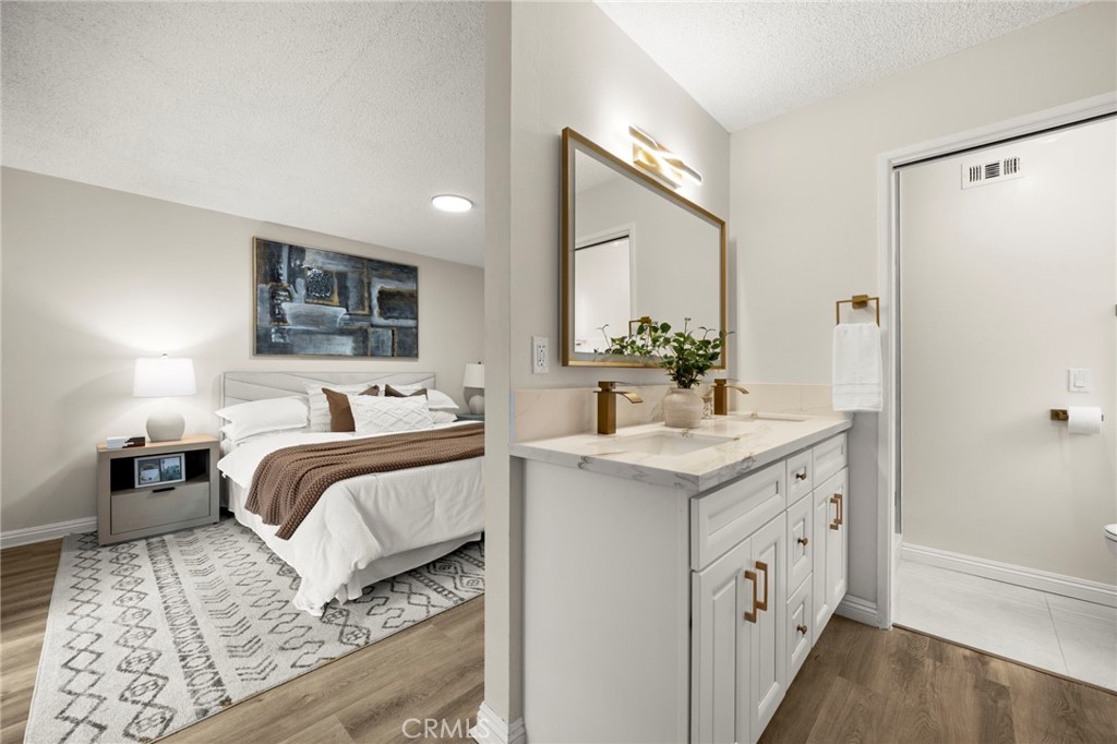 12817 Meadow Green Road La Mirada, CA 90638 - Photo 31 of 43 a bedroom with a bed and a chandelier