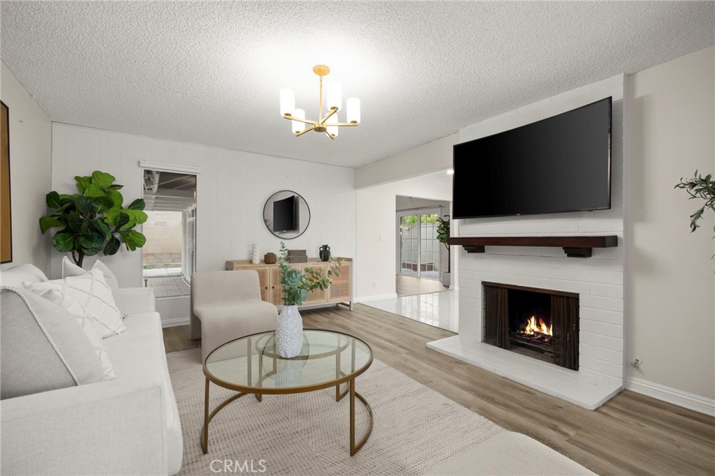 12817 Meadow Green Road La Mirada, CA 90638 - Photo 4 of 43 a living room with furniture a fireplace and a flat screen tv