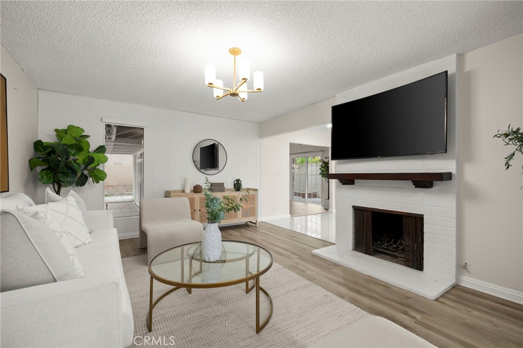 12817 Meadow Green Road La Mirada, CA 90638 - Photo 5 of 43 a living room with furniture a flat screen tv and a fireplace