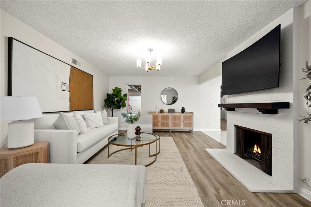 12817 Meadow Green Road La Mirada, CA 90638 - Photo 6 of 43 a living room with furniture and a fireplace