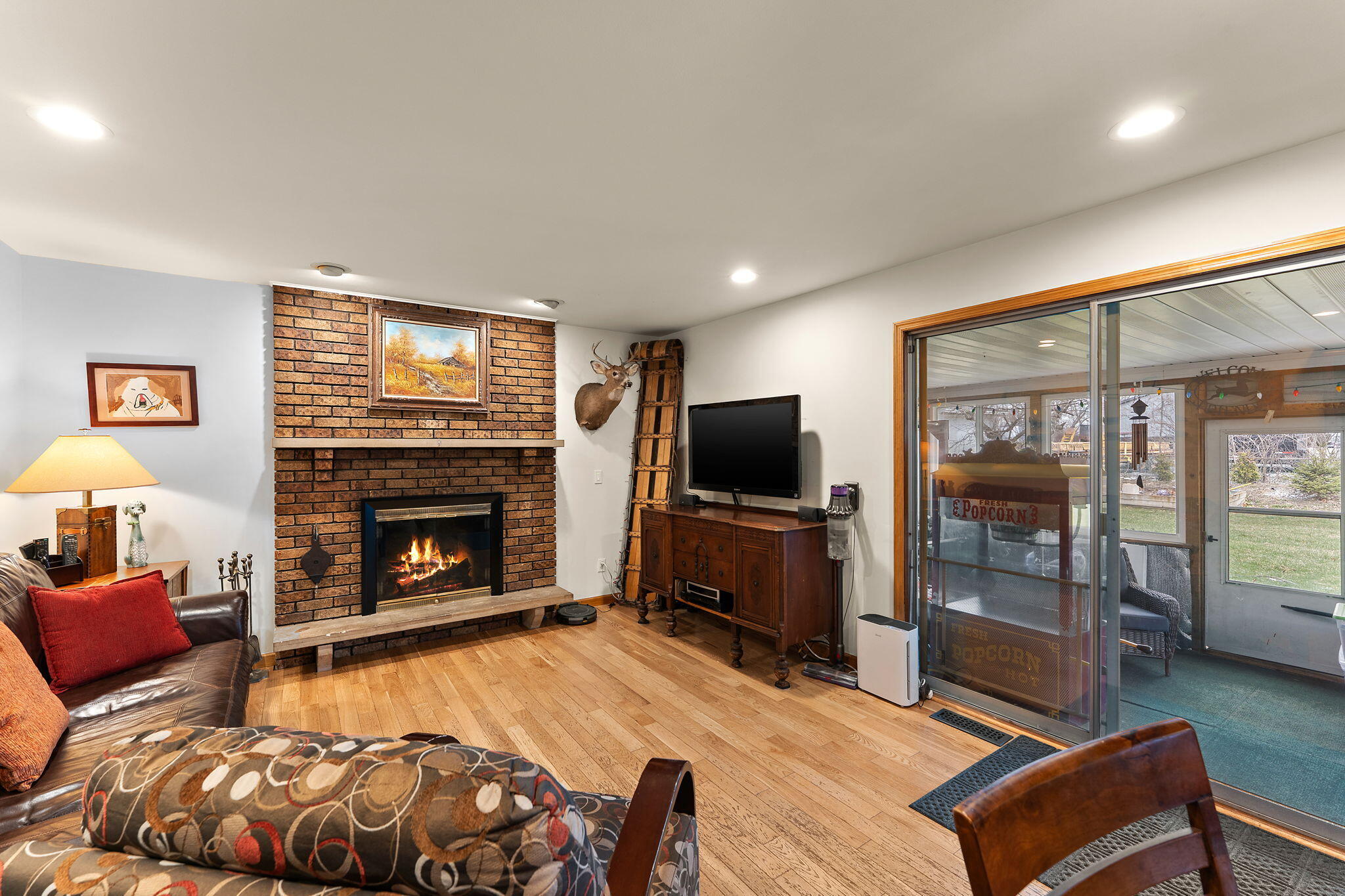3910 West 106th Lane Crown Point, IN 46307 - Photo 13 of 31 a bedroom with furniture a flat screen tv and a fireplace