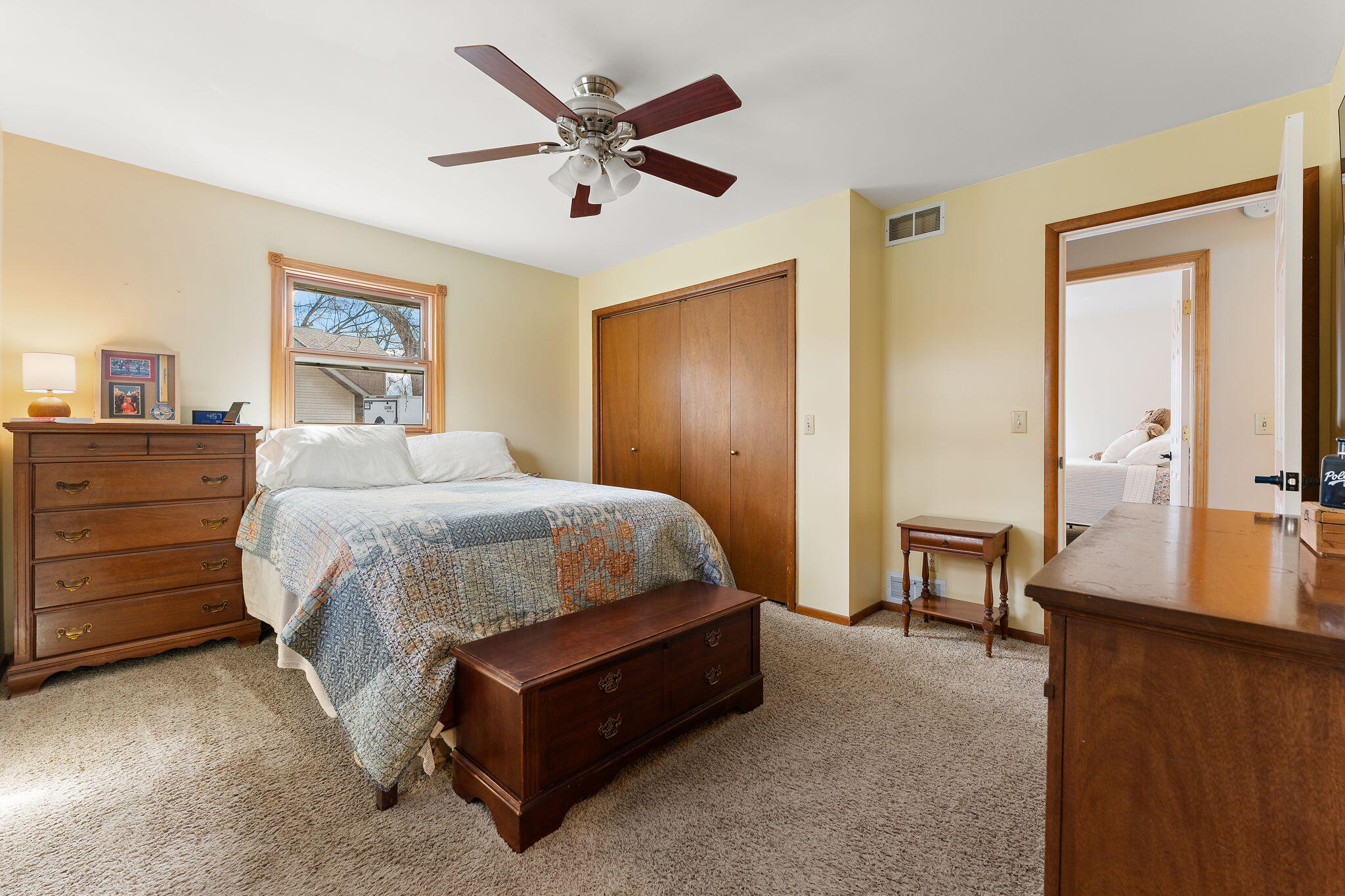 3910 West 106th Lane Crown Point, IN 46307 - Photo 15 of 31 a spacious bedroom with a bed a table and painting on the wall