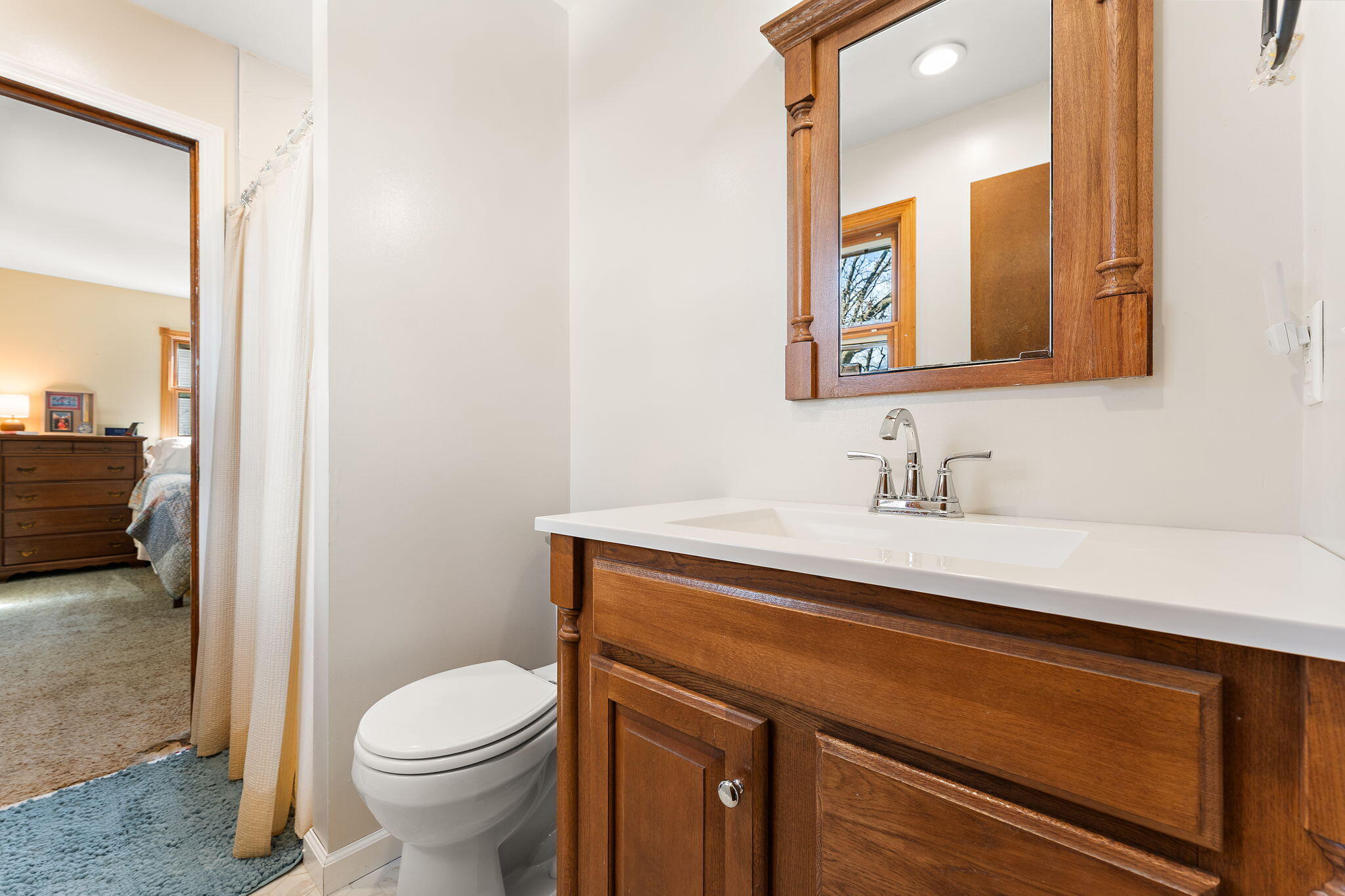 3910 West 106th Lane Crown Point, IN 46307 - Photo 17 of 31 a bathroom with a sink a toilet and a mirror