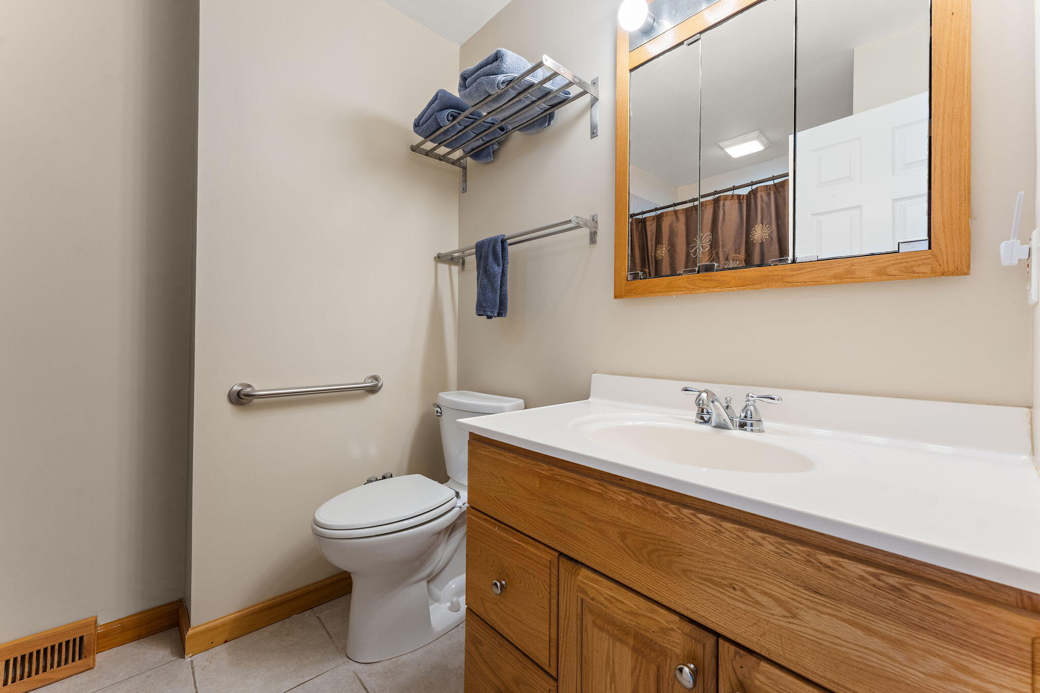 3910 West 106th Lane Crown Point, IN 46307 - Photo 21 of 31 a bathroom with a sink a toilet and mirror