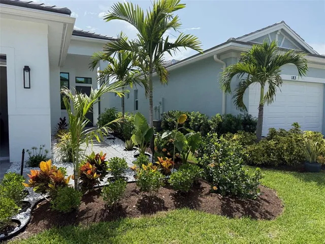 a plant in front of yellow house