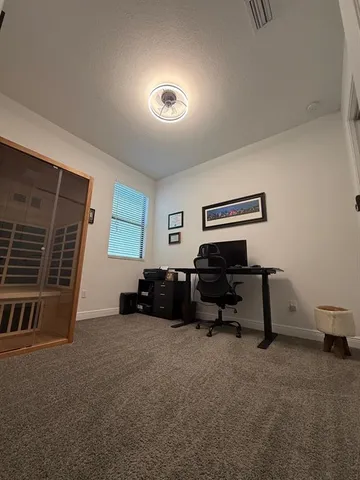 a view of a livingroom with furniture and a window