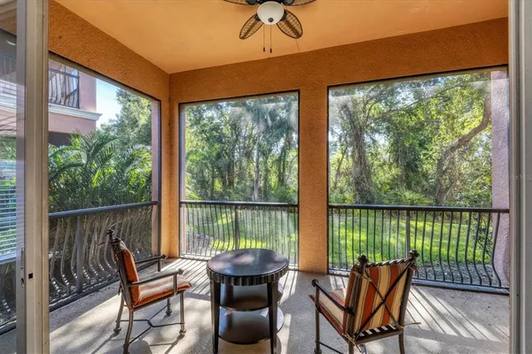 a view of a chairs and table in the balcony
