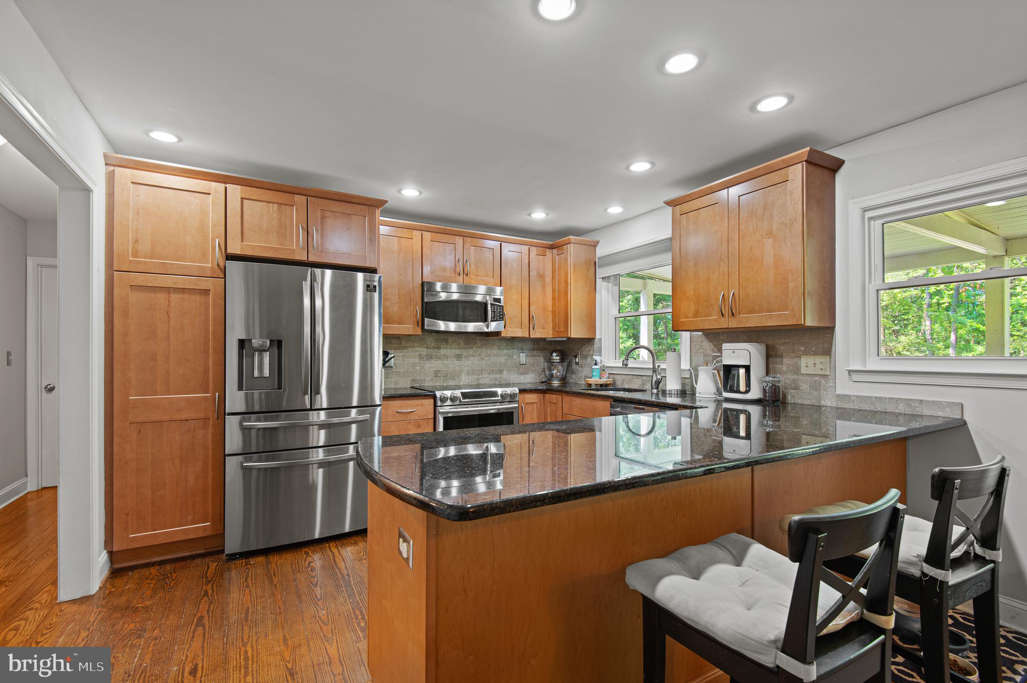 20000 Cameron Mill Road Parkton, MD 21120 - Photo 15 of 57 a kitchen with stainless steel appliances granite countertop a refrigerator a sink dishwasher a stove and a refrigerator with wooden floor