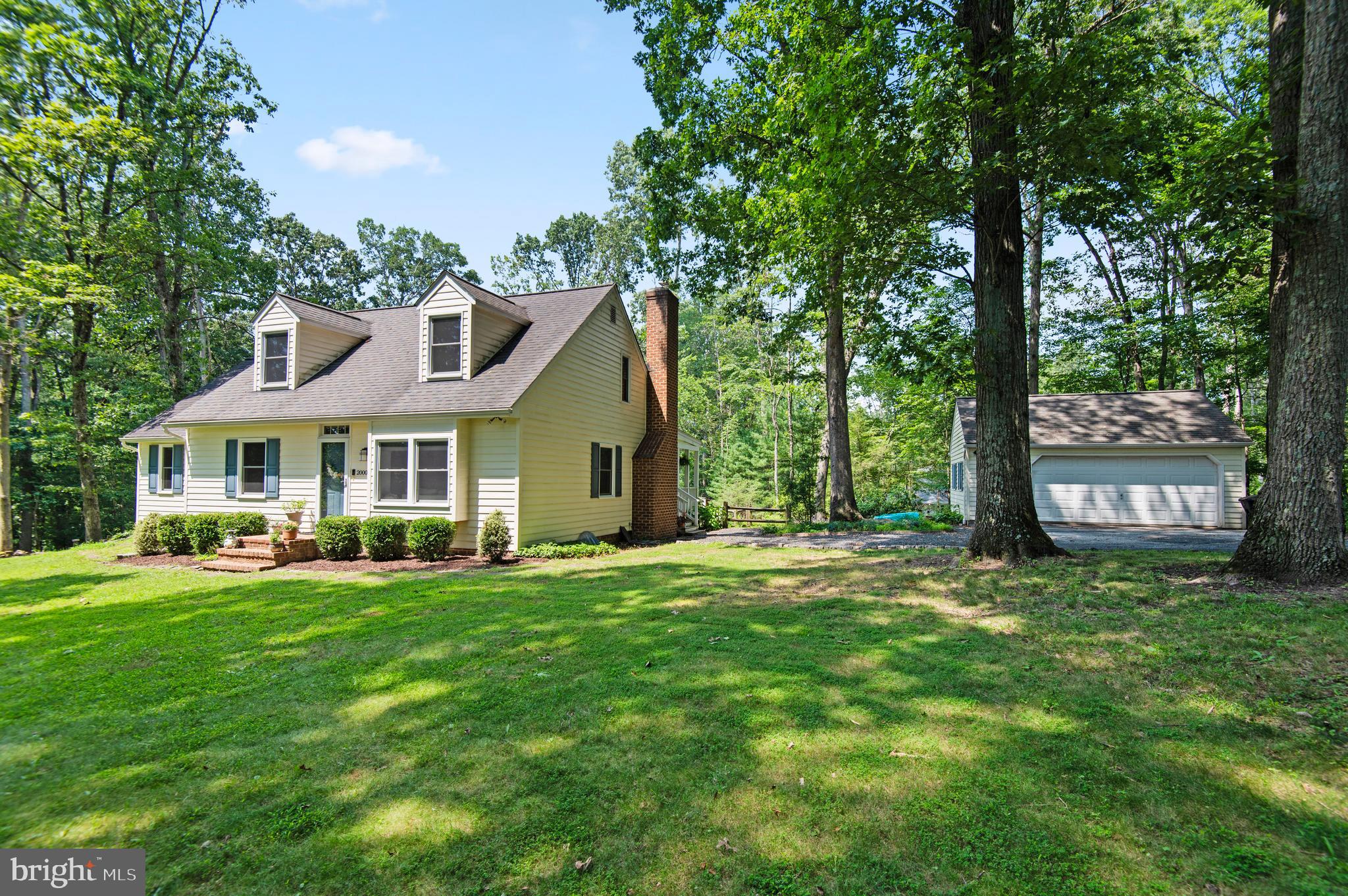 20000 Cameron Mill Road Parkton, MD 21120 - Photo 2 of 57 a front view of a house with a garden and trees