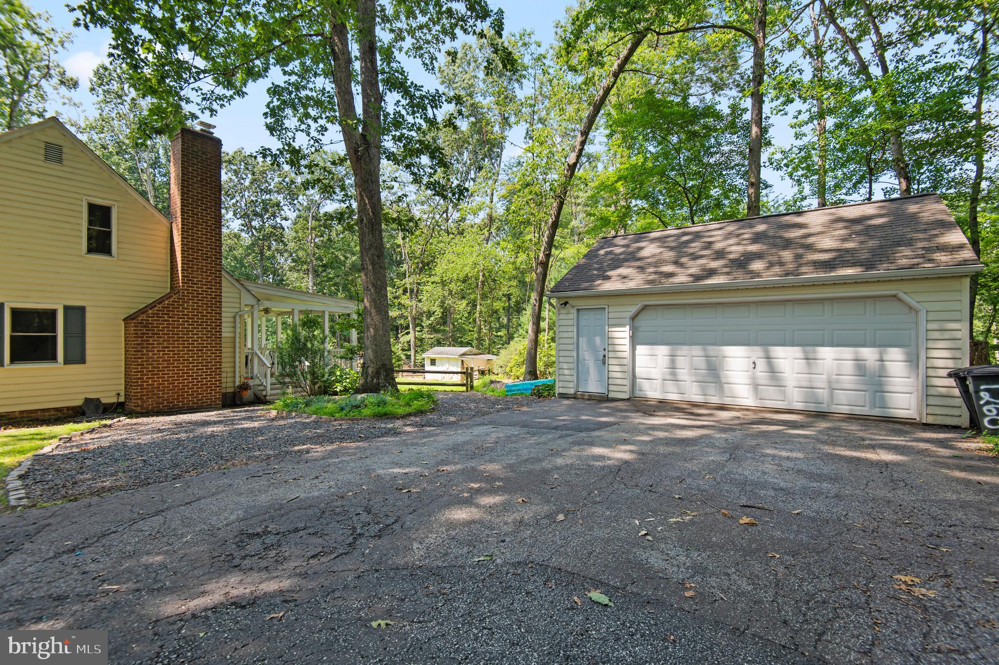 20000 Cameron Mill Road Parkton, MD 21120 - Photo 50 of 57 a front view of a house with a yard and garage
