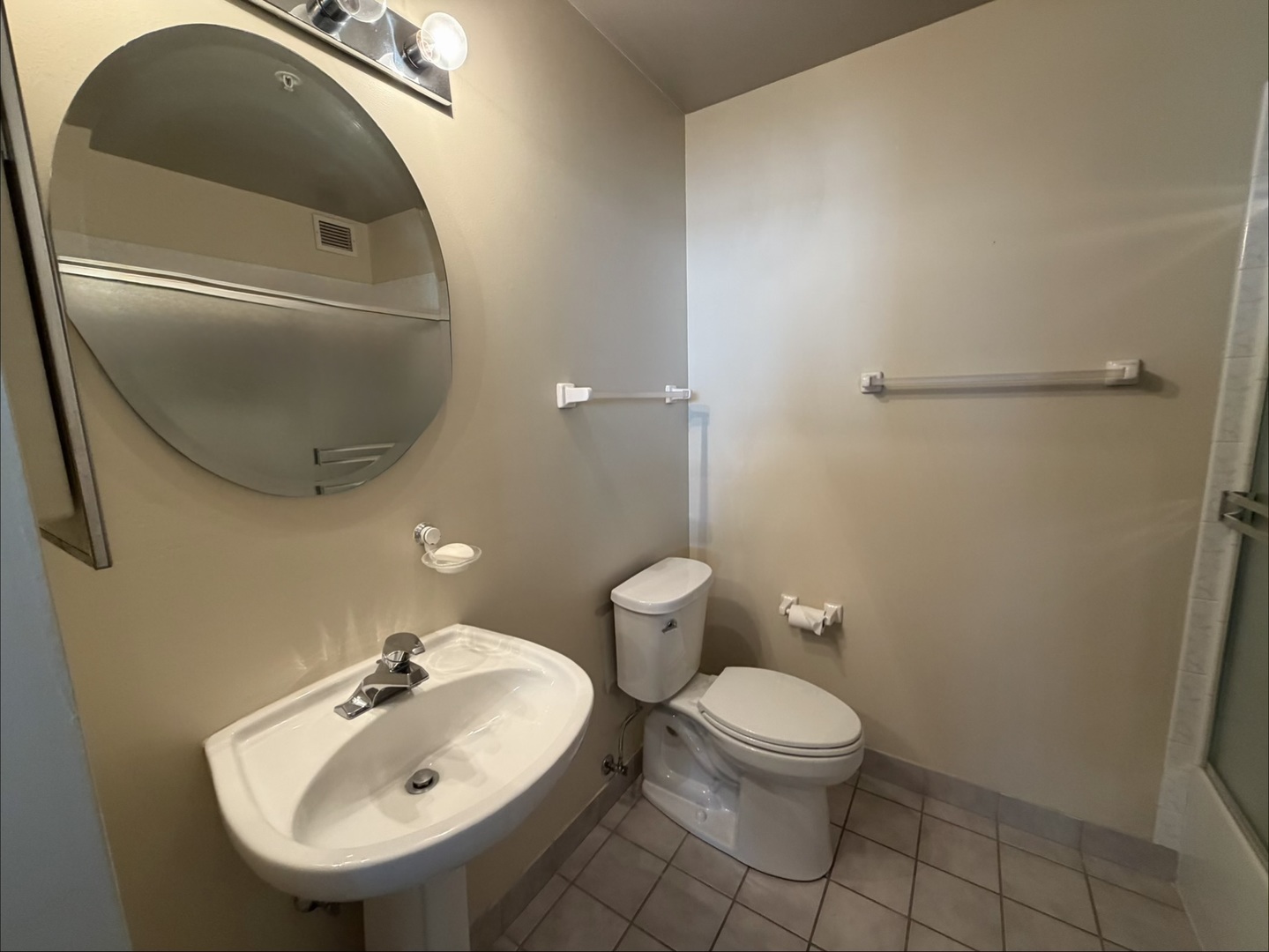 21 West Chestnut Street, Unit 1101 Chicago, IL 60610 - Photo 12 of 16 a bathroom with a toilet sink and mirror