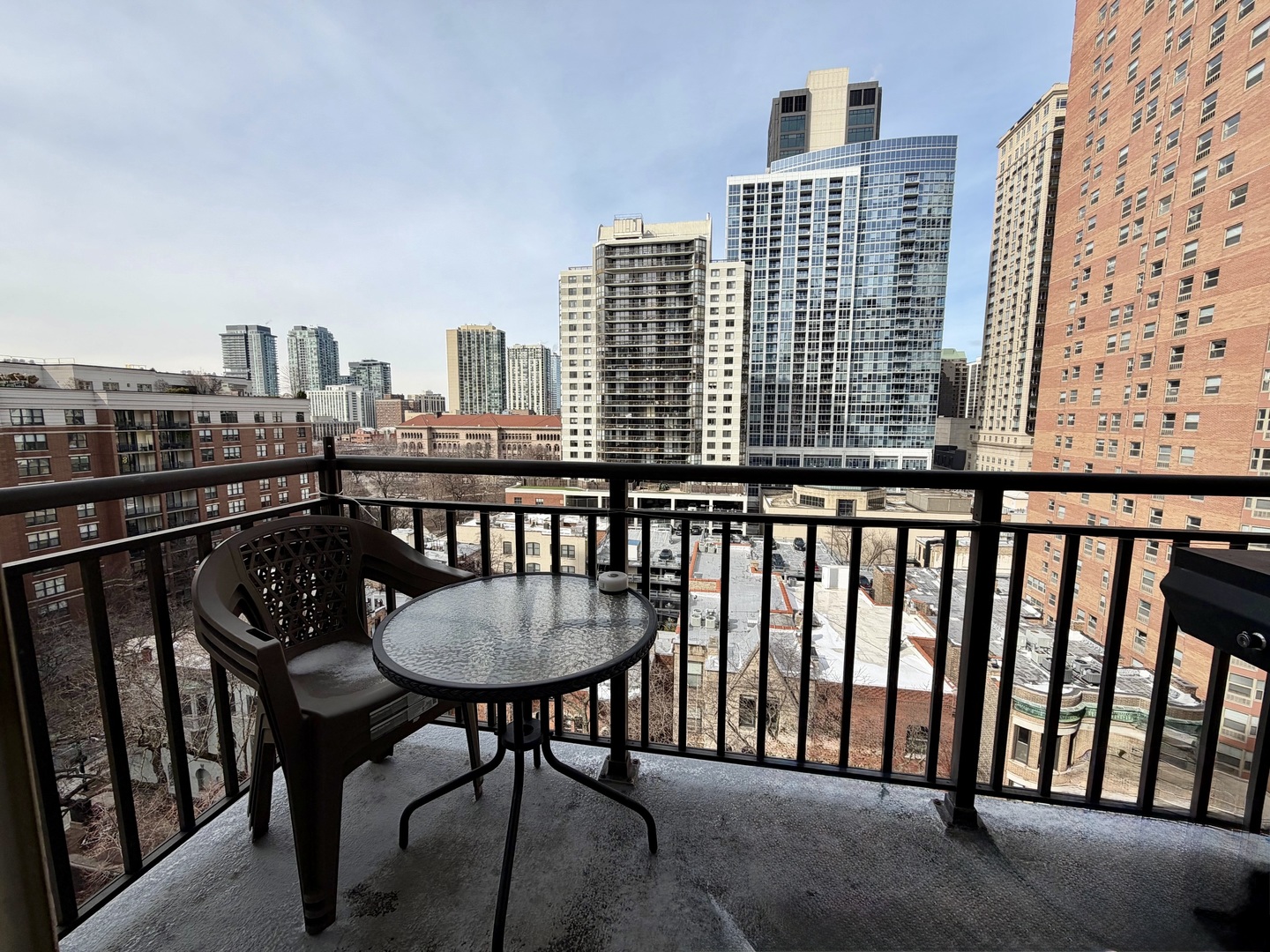 21 West Chestnut Street, Unit 1101 Chicago, IL 60610 - Photo 5 of 16 a view of a balcony with a table and chairs