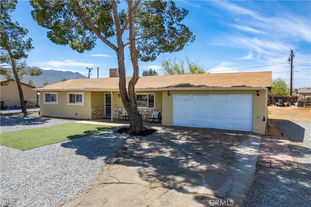 10277 Kiavan Road Apple Valley, CA 92308 - Photo 1 of 1 a view of a house with a yard