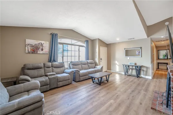 a kitchen with stainless steel appliances a dining table chairs stove and refrigerator