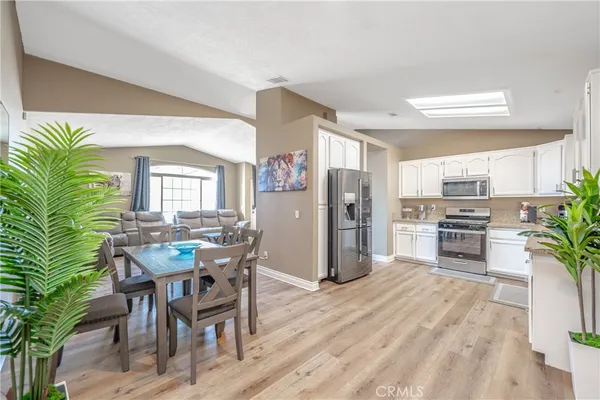 a kitchen with white cabinets and white appliances