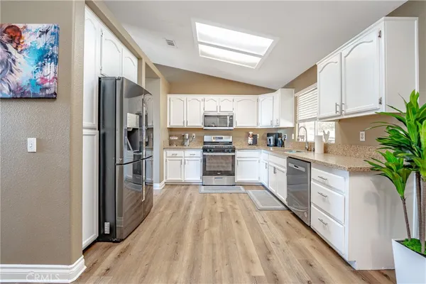 a utility room with wooden floor washer and dryer