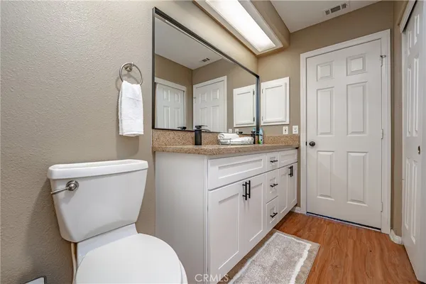 a bedroom with a bed and a night stand