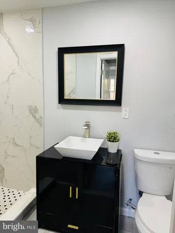 a view of an empty room with wooden floor and window