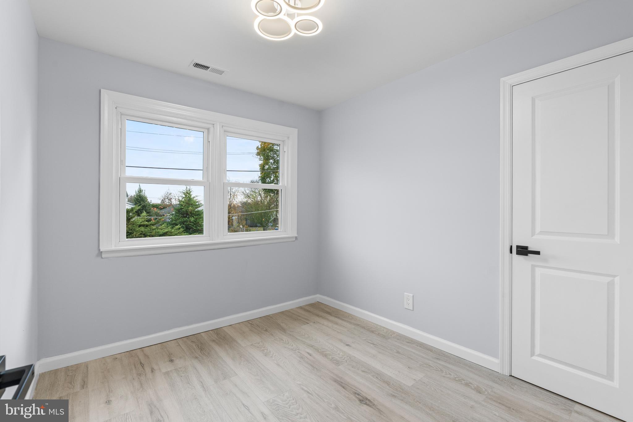 11046 Ferndale Street Philadelphia, PA 19116 - Photo 20 of 37 an empty room with wooden floor and windows