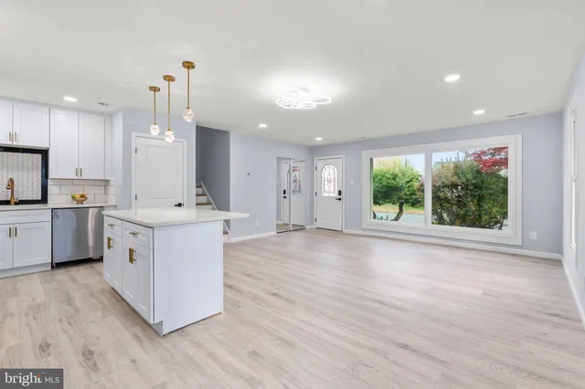 a view of a kitchen with a sink and a refrigerator