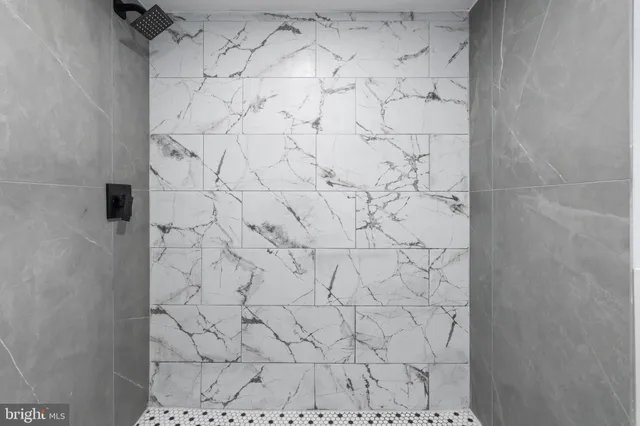 an empty room with wooden floor and stairs