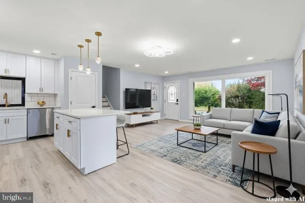 a kitchen with stainless steel appliances kitchen island hardwood floor sink stove and a window