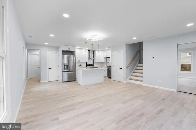 a view of kitchen with wooden floor and windows