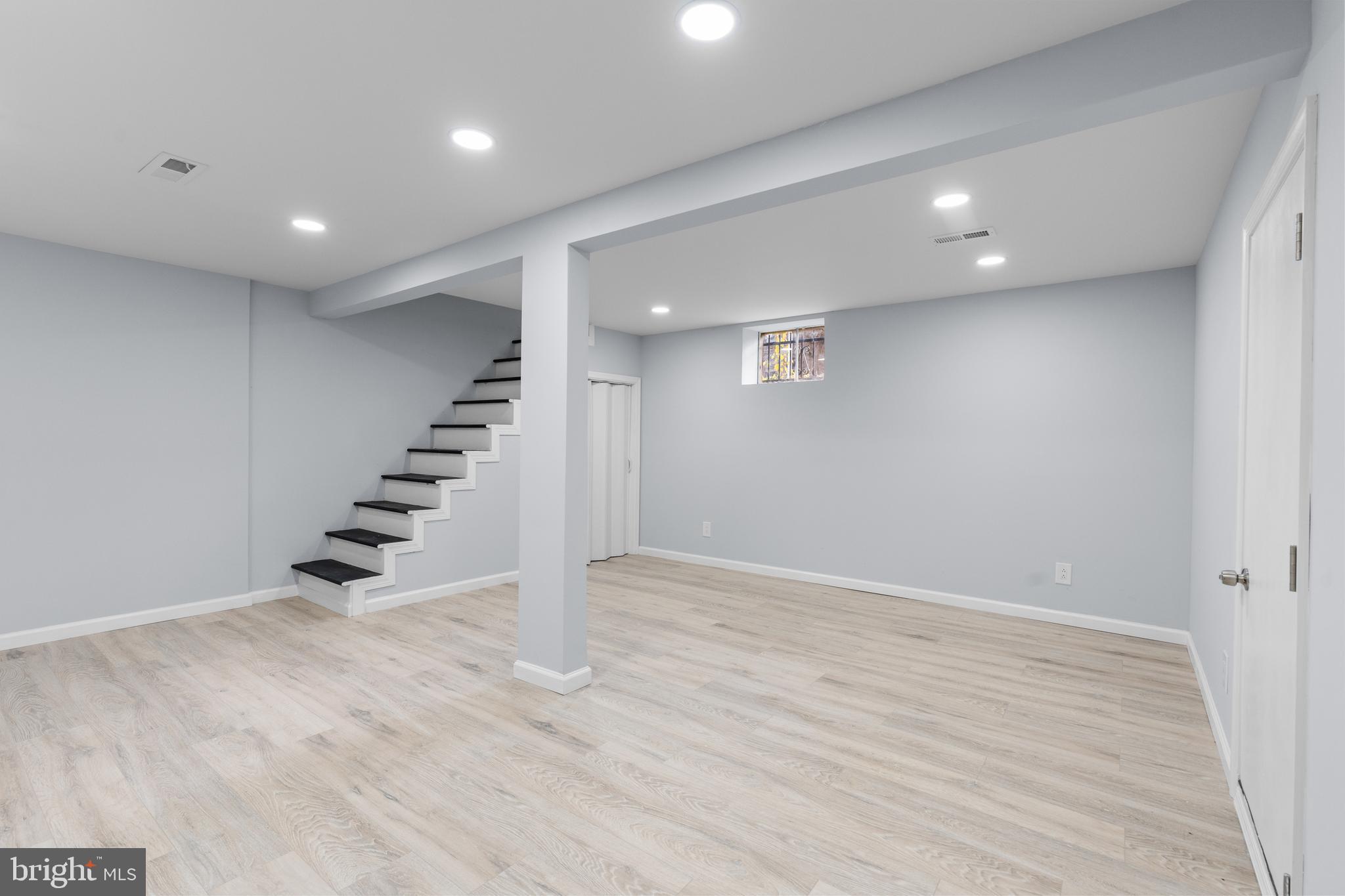 11046 Ferndale Street Philadelphia, PA 19116 - Photo 31 of 37 an empty room with wooden floor and stairs