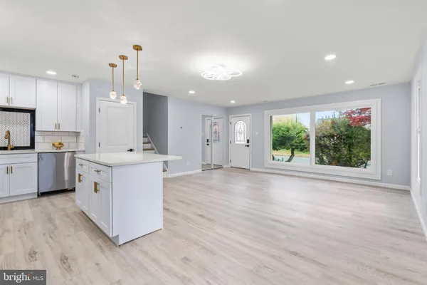 a view of a kitchen with a sink and a refrigerator