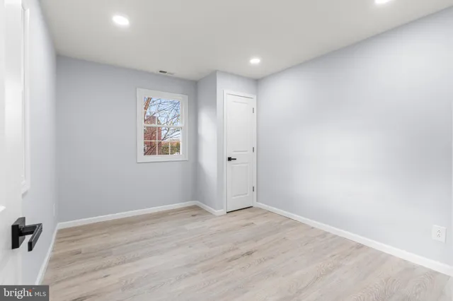 an empty room with windows and closet