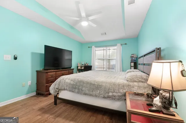 a bedroom with a bed and a flat screen tv