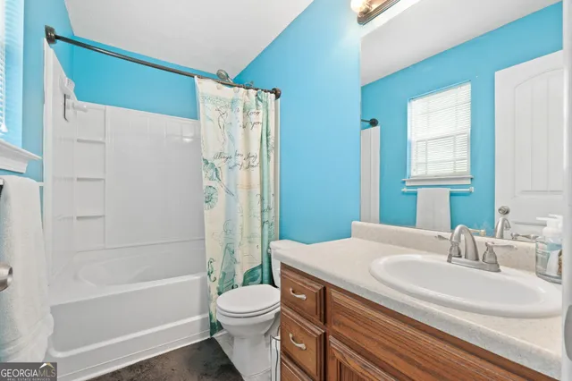 a bathroom with a sink a toilet and a bathtub