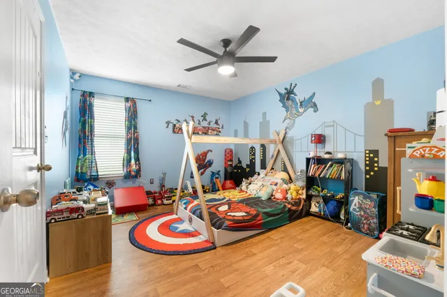a bed room with furniture and a flat screen tv
