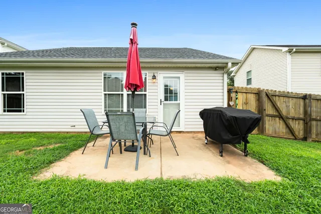 a view of a backyard with table and chairs