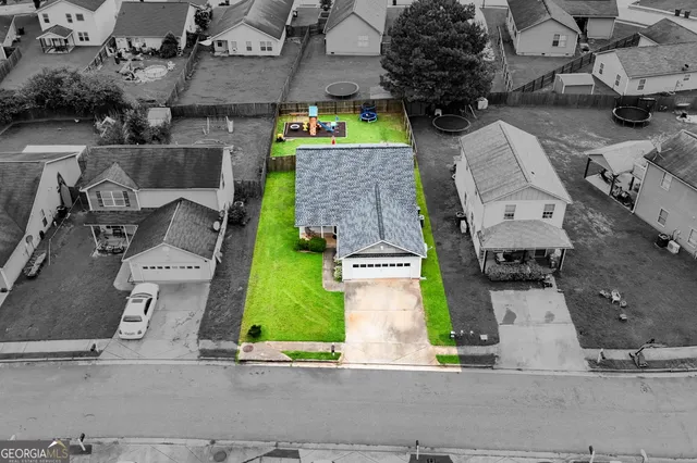 an aerial view of residential houses with outdoor space