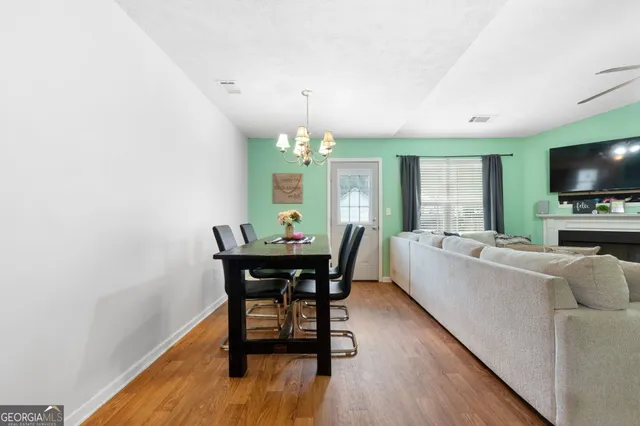 a view of a dining room with furniture window and wooden floor