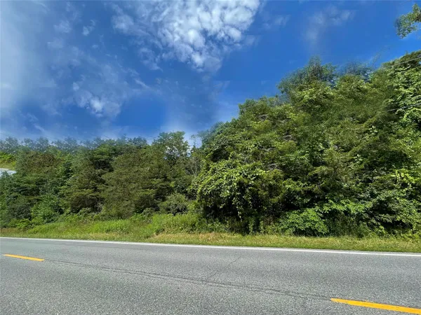a view of a road with a building in the background
