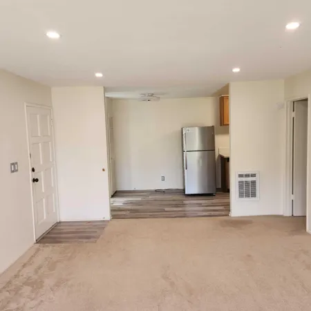a view of a kitchen with a sink and a refrigerator
