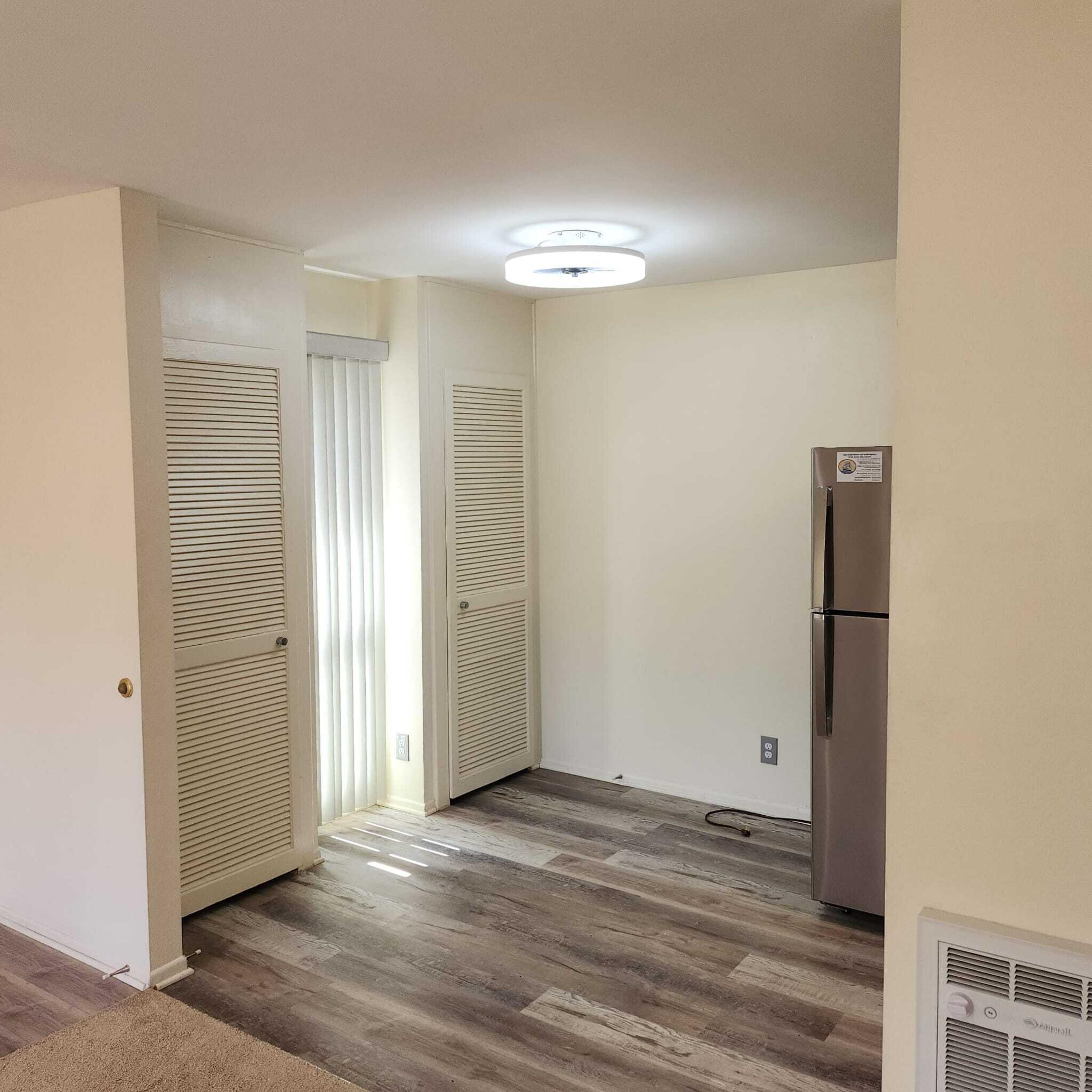 5518 Armitos Avenue, Unit 86 Goleta, CA 93117 - Photo 8 of 10 an empty room with wooden floor and windows
