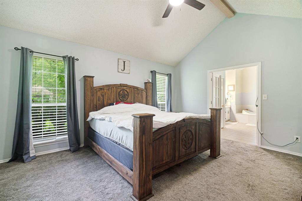 455 Timber Lakes Drive Powderly, TX 75473 - Photo 7 of 18 a bed sitting in a spacious bedroom next to a window