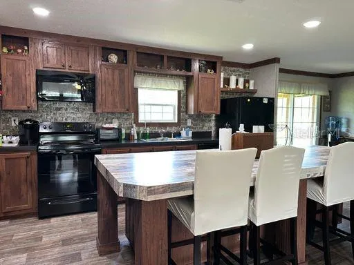 a large kitchen with a table and chairs