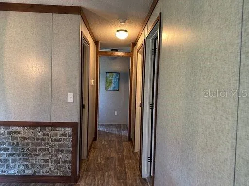 a view of hallway with wooden floor