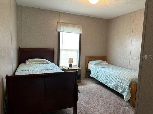 a bedroom with a bed and window