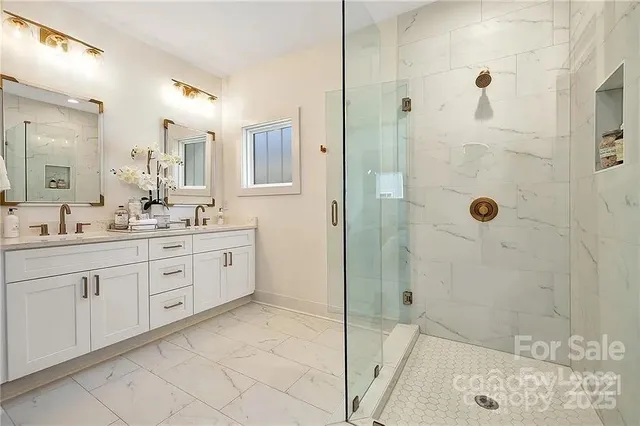 a spacious bathroom with a shower sink and mirror