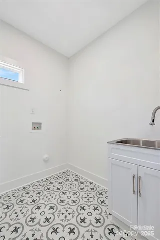 a room with a sink and cabinets