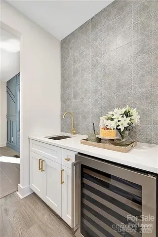 a sink with a white cabinets