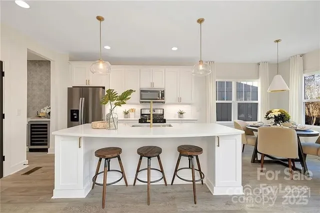 a kitchen with kitchen island granite countertop a table and chairs in it